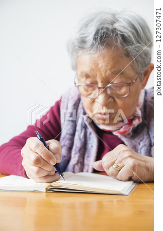An 89-year-old grandmother writing a diary 127307471