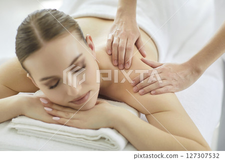 Massage therapist doing back massage for shoulder, spa assistant helps pain relaxing technique Massage therapist doing back massage for shoulder, spa assistant helps pain relaxing technique 127307532