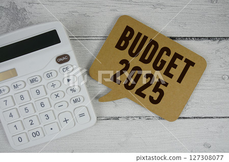 Budget 2025 text with calculator on wooden background 127308077