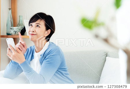 Middle-aged woman making a video call on a smartphone 127308479