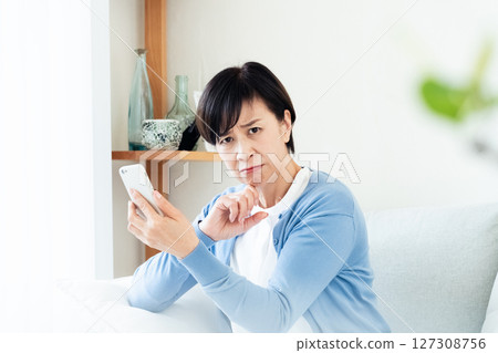 Middle-aged woman making a video call on a smartphone 127308756