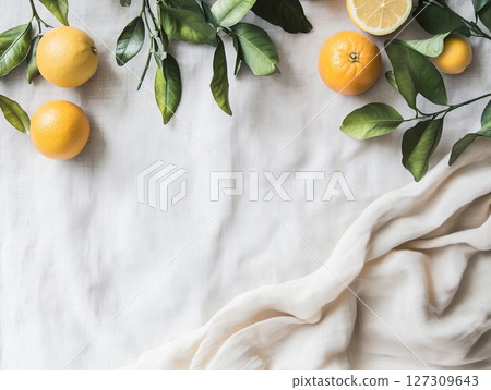 Oranges and lemon slices with green leaves on white cloth. Bright display for culinary or wellness themes, great for fresh or rustic ideas. Perfect for natural or fruit visuals. Oranges and lemon slices with green leaves on white cloth. Bright display for culinary or wellness themes, great for fresh or rustic ideas. Perfect for natural or fruit visuals. 127309643