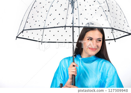 Woman with blue raincoat and umbrella studio portrait Woman with blue raincoat and umbrella studio portrait 127309948