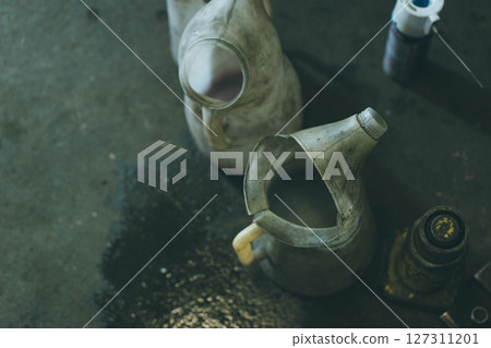 Oil jug on the floor of an auto repair shop Oil jug on the floor of an auto repair shop 127311201