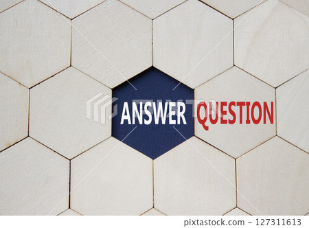 Answer or Question symbol. Concept word Answer or Question on wooden comb puzzle. Beautiful deep blue background. Business and Answer or Question concept. Copy space 127311613