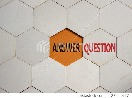 Answer or Question symbol. Concept word Answer or Question on wooden comb puzzle. Beautiful orange background. Business and Answer or Question concept. Copy space 127311617