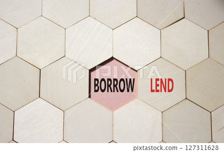 Lend or Borrow symbol. Concept word Lend or Borrow on wooden comb puzzle. Beautiful pink background. Business and Lend or Borrow concept. Copy space 127311628