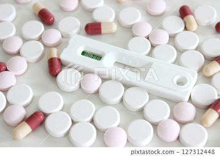 Positive test result of Covid-19 antigen test kit and drugs isolated on the white background 127312448