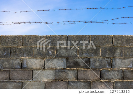 Barbed Wire Above Concrete Block Wall 127313215