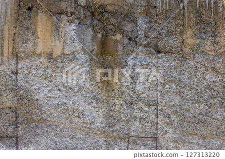 Abstract weathered concrete wall texture with visible aggregate. 127313220