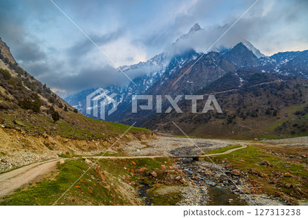 Majestic mountains and serene river in spring ravine landscape 127313238