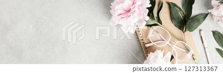 Flat Lay with Peonies, Notebook, and Eyeglasses on Gray Surface 127313367
