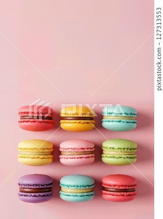 Vibrant Assorted French Macarons Arranged in Colorful Rows on Pastel Pink Background, Gourmet Dessert Selection for Bakery, Patisserie, Cafe, and Confectionery Concepts 127313553