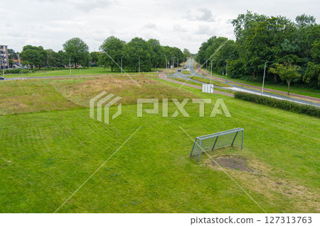 Grass football field playground aerial drone view from empty soccer field. Grass football field playground aerial drone view from empty soccer field. 127313763