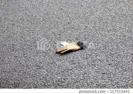Gloves dropped on the road 127313941