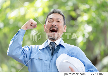 Men in work clothes, fresh greenery, fist pump 127314020