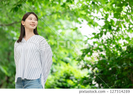 A woman smiling in the fresh green 127314289