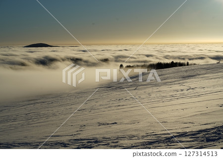 Winter landscape, a ski track in the snow, mountains of the Wasserkuppe. Wasserkuppe, in Hesse, Germany. Traveling to the mountains in the winter. 127314513