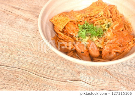 stir ramen Japanese noodles with slice pork sausage and tofu with cabbage in Korean kimchi sauce on bowl 127315106