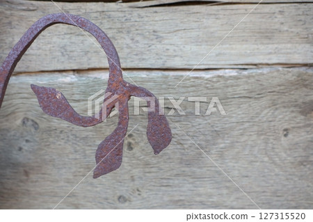 Rustic Iron Leaf Design Crafted with Care on Beautiful Wooden Background Setting Rustic Iron Leaf Design Crafted with Care on Beautiful Wooden Background Setting 127315520