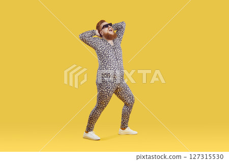Funny happy plus size man wearing crazy leopard pajamas having fun in fashion studio Funny happy plus size man wearing crazy leopard pajamas having fun in fashion studio 127315530