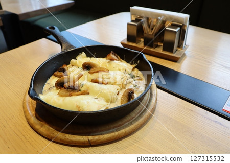 Satisfy cravings with baked cheese and flavorful mushrooms, cooked in a cast iron skillet Satisfy cravings with baked cheese and flavorful mushrooms, cooked in a cast iron skillet 127315532