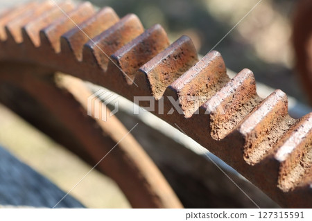 CloseUp View of Rusty Gear Teeth Found in a Detailed Industrial Setting and Environment 127315591