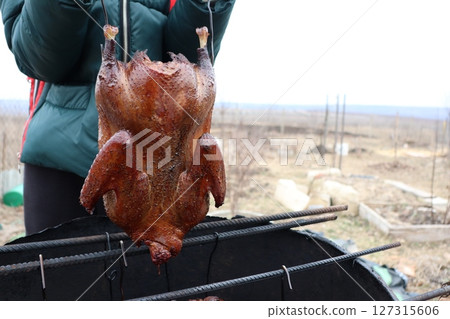 Enjoying the art of Smoked Chicken Cooking Outdoors during the beautiful Winter season 127315606