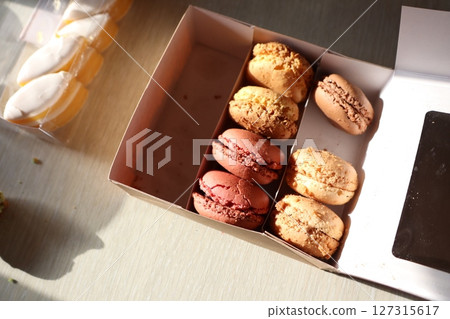 A Delicious and Colorful Assortment of Artisanal Macarons Perfectly Packaged in a Box 127315617