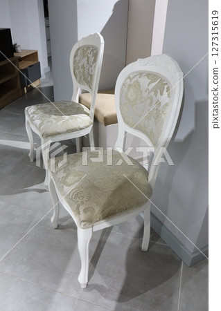 Experience the elegance of vintage chairs featuring intricate and exquisite upholstery design 127315619