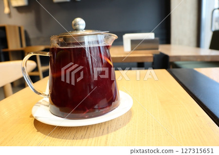 A Refreshing Herbal Tea Brewed in a Beautiful Transparent Glass Teapot for Enjoyment 127315651
