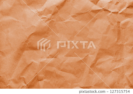 Recycled crumpled orange color paper texture. Wrinkled craft paper background, cardboard surface Recycled crumpled orange color paper texture. Wrinkled craft paper background, cardboard surface 127315754