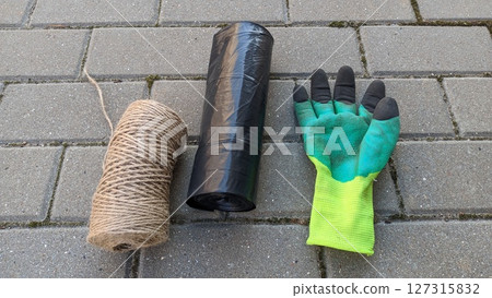 Gardening Supplies Essentials include gloves, twine for plants, and a trash bag for cleanup Gardening Supplies Essentials include gloves, twine for plants, and a trash bag for cleanup 127315832