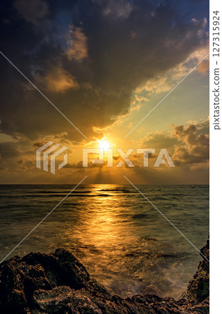 A fantastic view of Kannonzaki, Ishigaki Island, where the sun sets between the rocks A fantastic view of Kannonzaki, Ishigaki Island, where the sun sets between the rocks 127315924