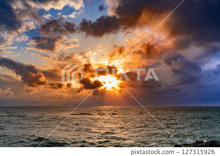 Sunset: A moment when the rocks and ocean of Kannonzaki, Ishigaki Island, are dyed in the sunset 127315926