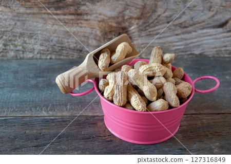 Ground peanuts in the bowl ,ingredient food. 127316849