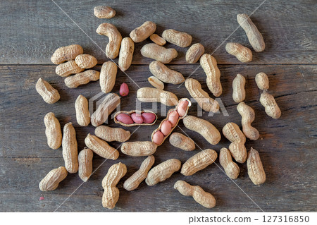 Ground peanuts on wood background ,ingredient food. 127316850