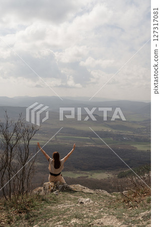Woman Mountain View, happy girl stretches arms atop hill during daytime to enjoy freedom and landscape. Woman Mountain View, happy girl stretches arms atop hill during daytime to enjoy freedom and landscape. 127317081
