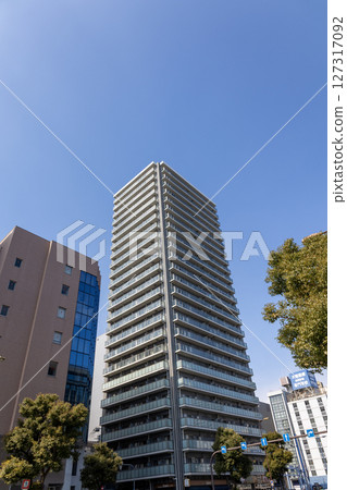 High-rise apartment building seen from below against the blue sky High-rise apartment building seen from below against the blue sky 127317092