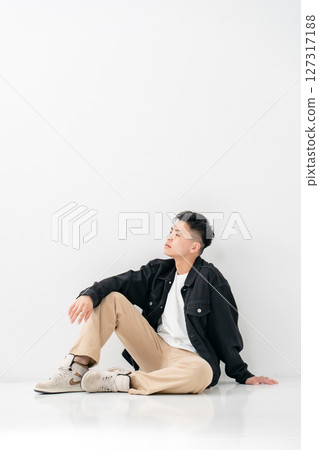 Young man portrait casual sitting Young man portrait casual sitting 127317188