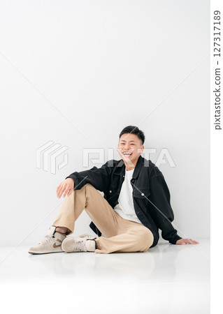 Young man portrait casual sitting Young man portrait casual sitting 127317189