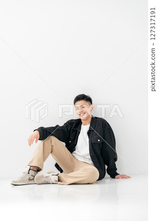 Young man portrait casual sitting 127317191