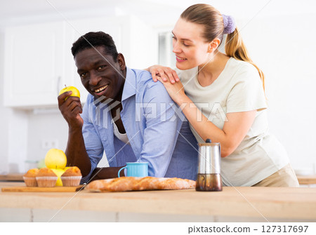 Wife and husband having breakfast in modern kitchen at home Wife and husband having breakfast in modern kitchen at home 127317697