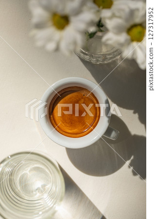 Cup of espresso coffee with glass of water Cup of espresso coffee with glass of water 127317952