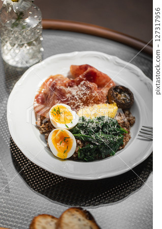 Portion of breakfast with buckwheat and egg Portion of breakfast with buckwheat and egg 127317956