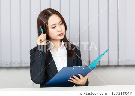 Worried Asian woman in a suit 01 Worried Asian woman in a suit 01 127318047