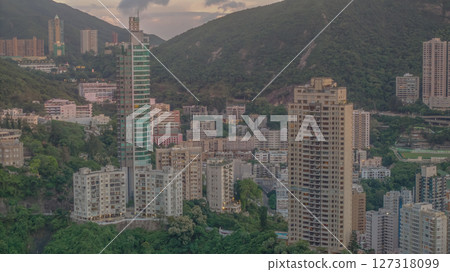 June 10 2025 Residential Skyscrapers Against a Green Mountain Backdrop at Sunset June 10 2025 Residential Skyscrapers Against a Green Mountain Backdrop at Sunset 127318099