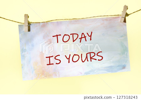 Motivational words TODAY IS YOURS written on a colorful sign on a rope with clothespins Motivational words TODAY IS YOURS written on a colorful sign on a rope with clothespins 127318243