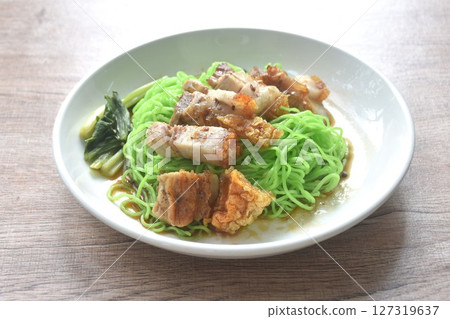 Chinese jade noodles topping roasted crispy pork dipping sweet soy sauce on plate  127319637
