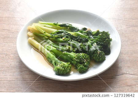 fried Kailaan Chinese kale dressing oyster sauce with chop garlic and salty fish on plate 127319642